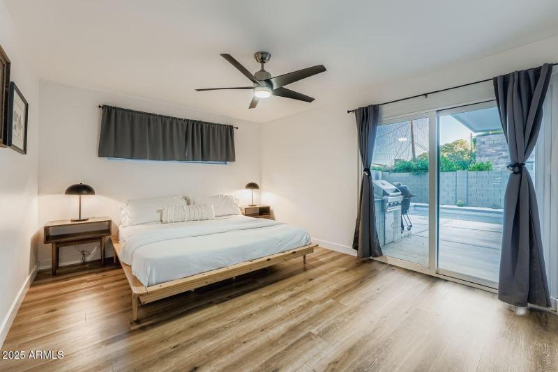 PRIMARY BEDROOM W/ PATIO AND POOL ACCESS