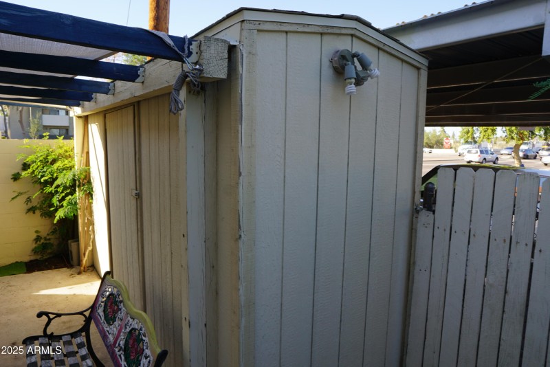 Storage unit by carport in back