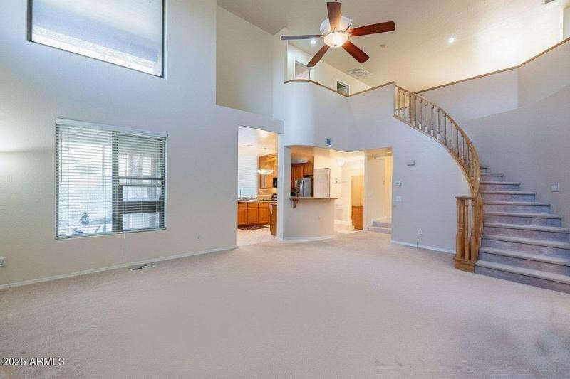 Living room toward kitchen and stairs