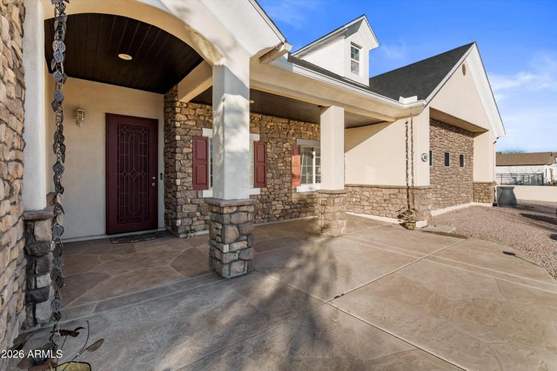 Covered Front Patio With Seating Space