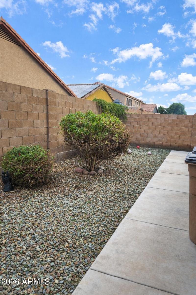 Backyard with pebbled landscaping and wa