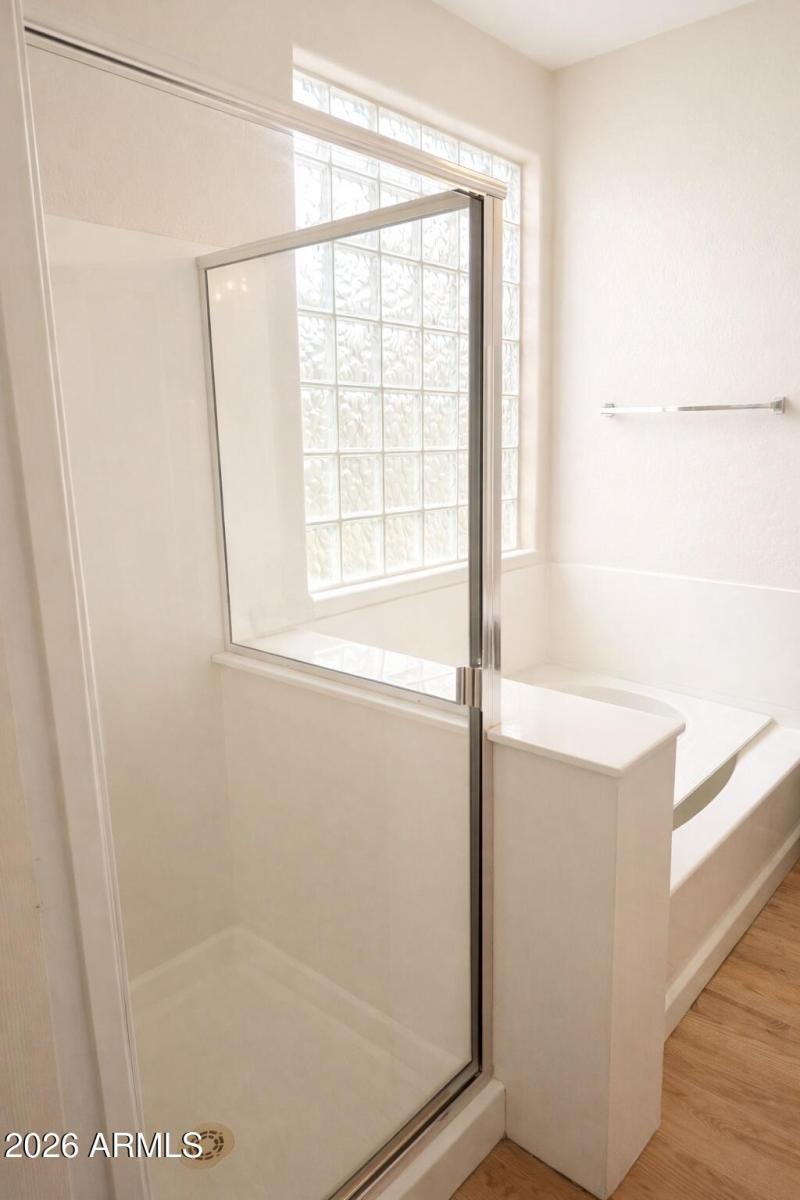 Modern bathroom with glass and wood acce