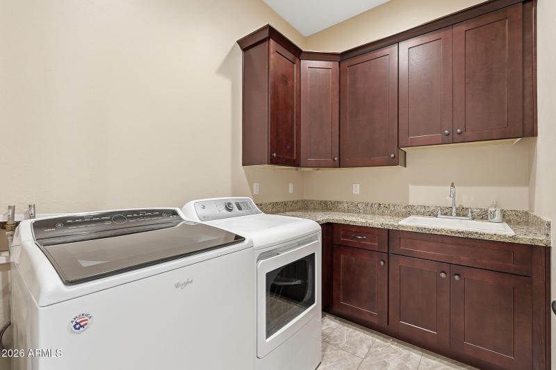 Large laundry with sink and cabinets