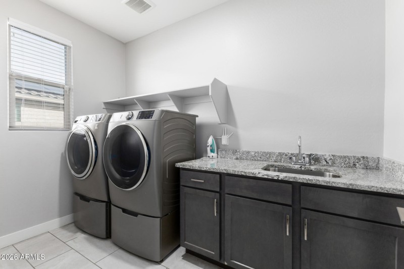 Laundry room with sink and cabinets