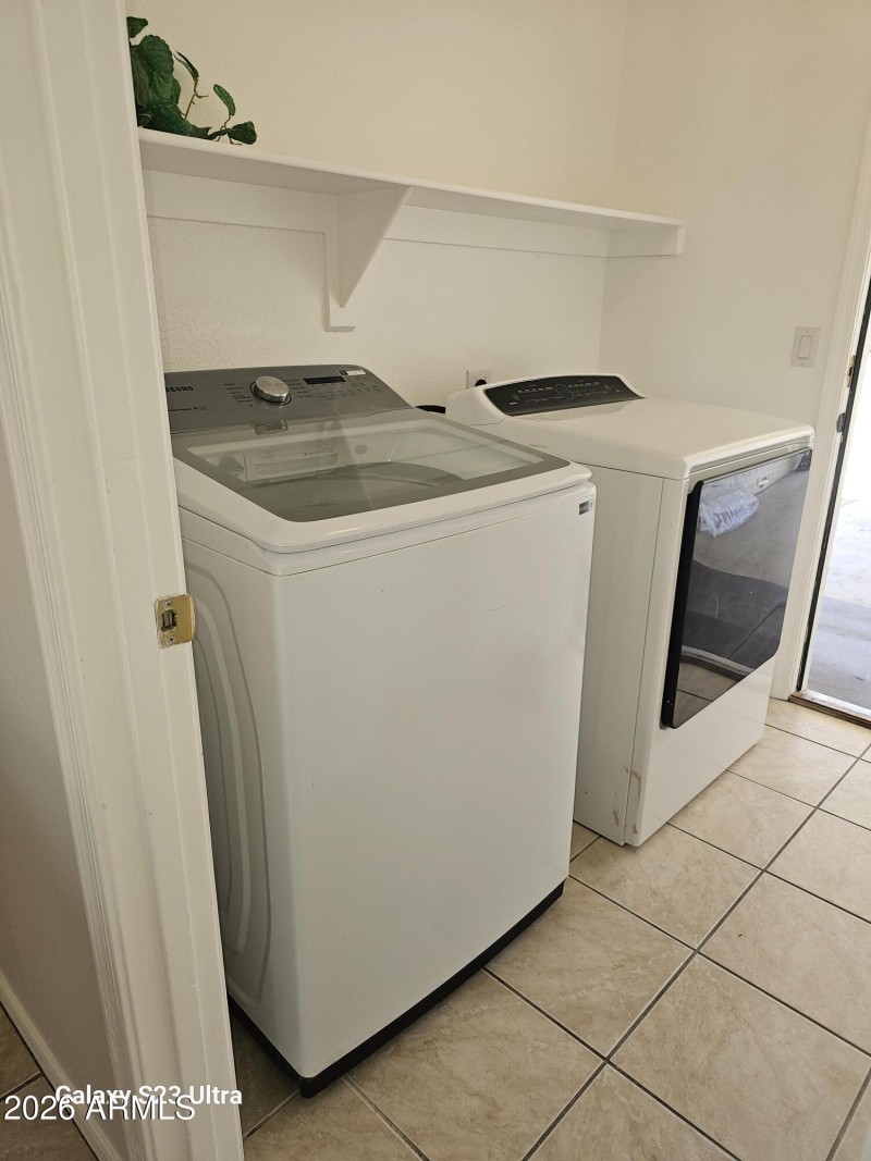 inside laundry room w/ built in shelve