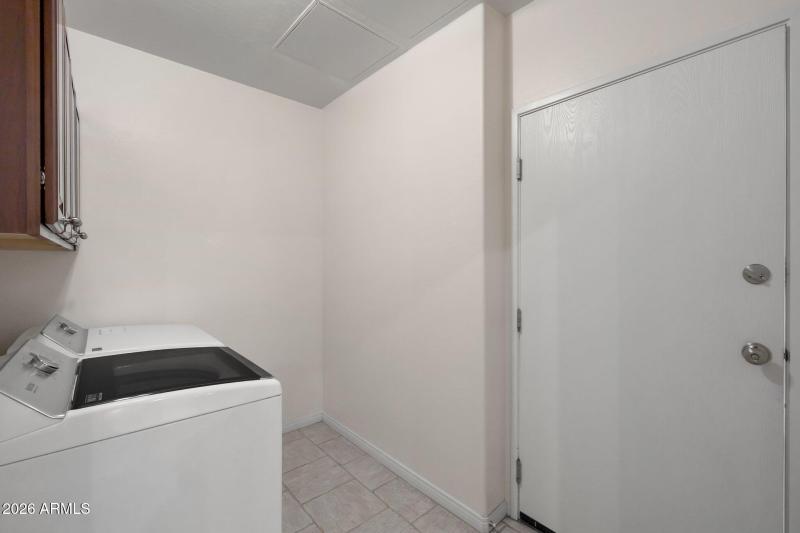 Laundry room includes newer washer & dry