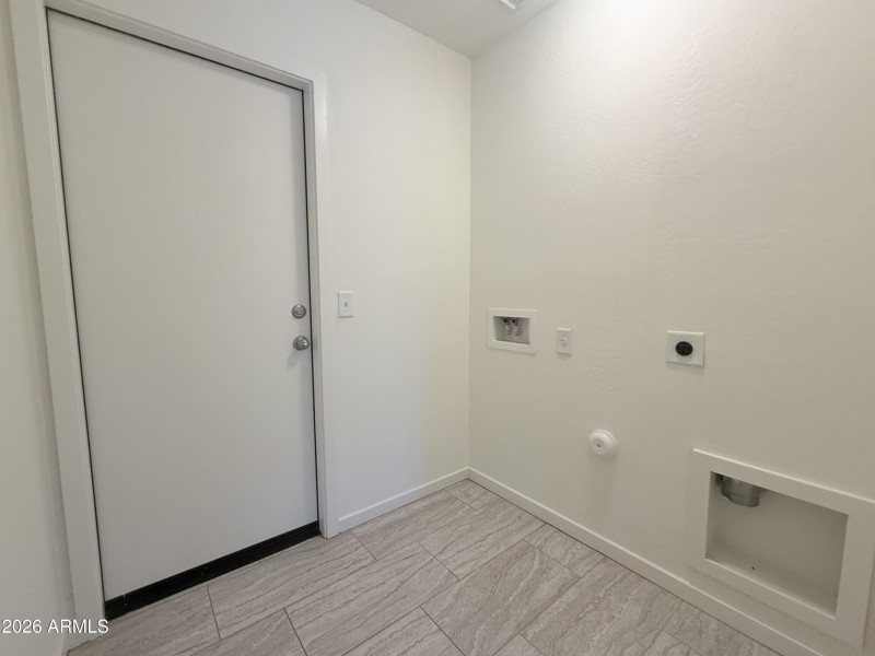 Laundry area fits full size washer and d