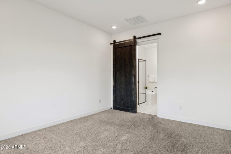 Primary bedroom with barn door