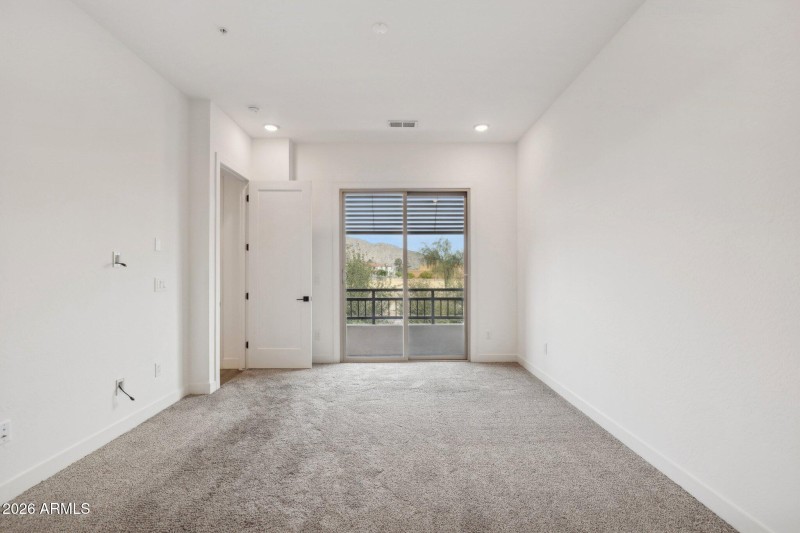 Primary bedroom with slider to balcony