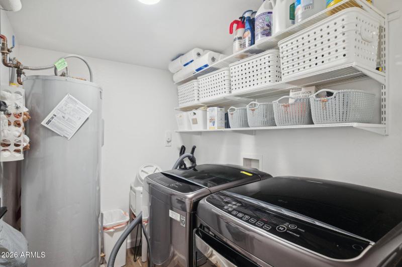 Inside laundry with storage