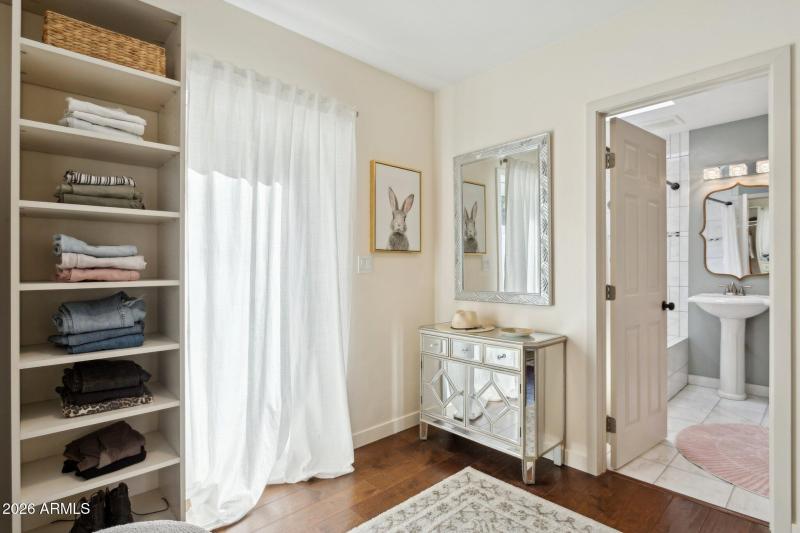 Walk-in closet leads to bath