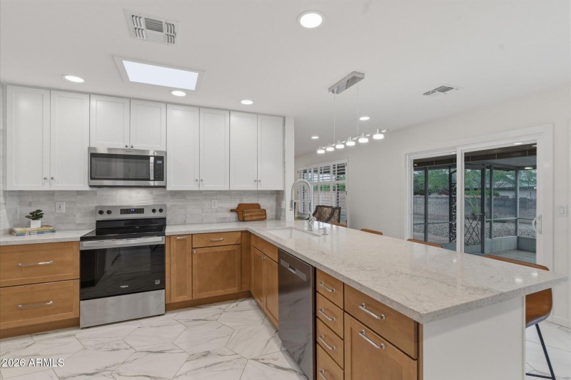 Kitchen flows to screened in patio