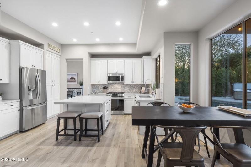 Kitchen looks out to backyard