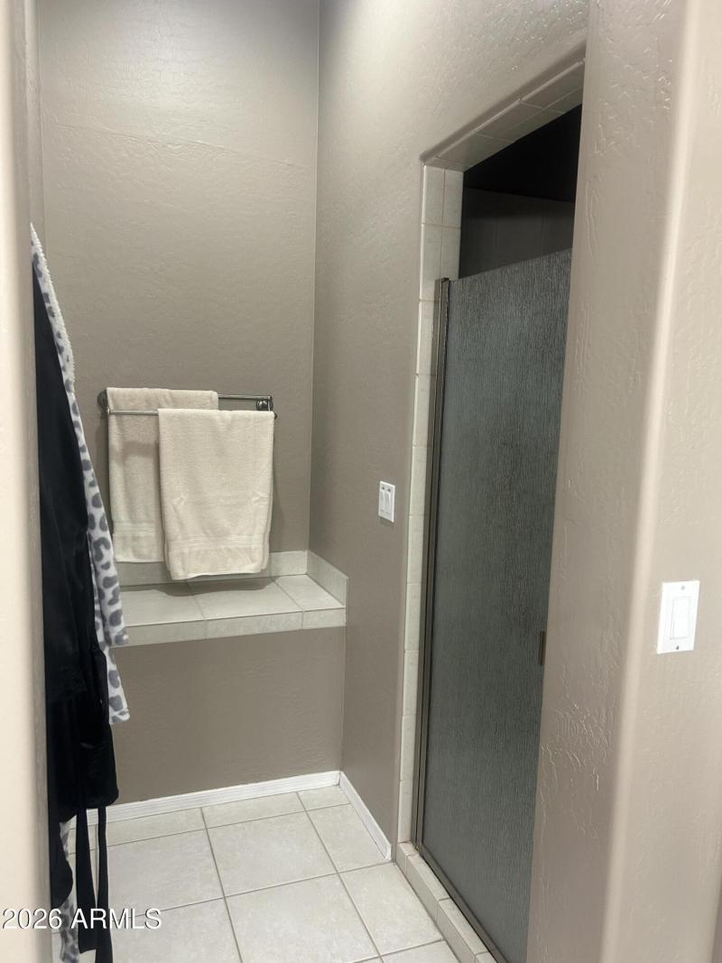 Niche beside master shower and closet