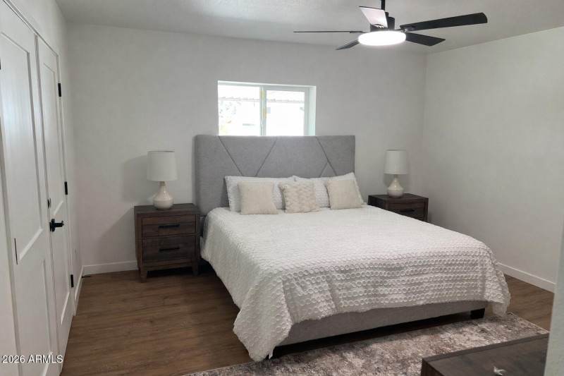 Modern bedroom with artistic headboard.