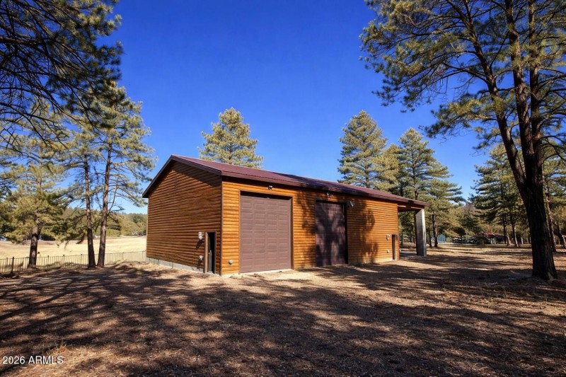Wooden garage in forest setting