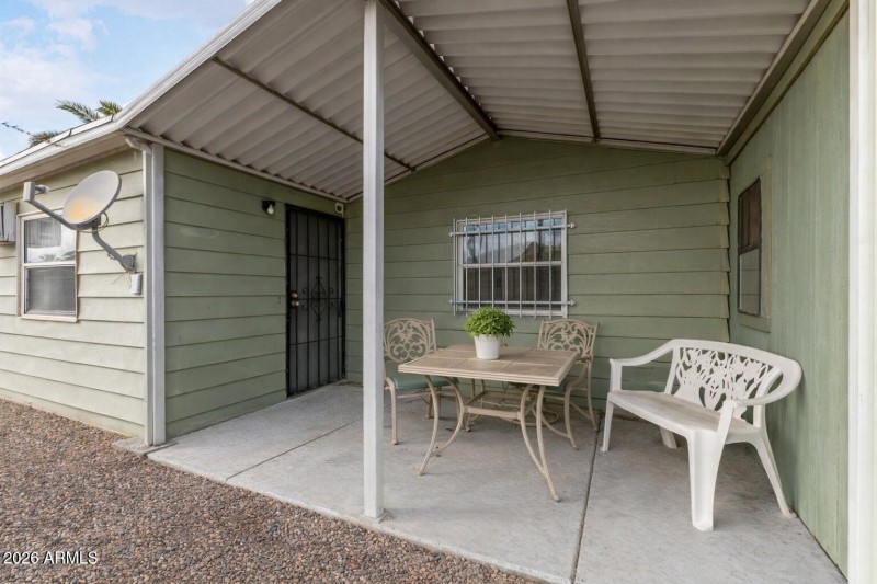 Sunny patio with green house details