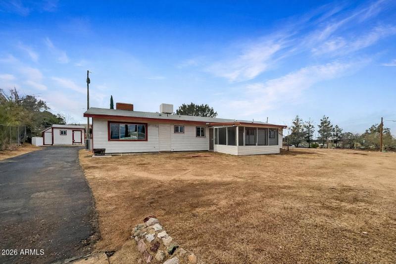 Rural house with red trim and shed
