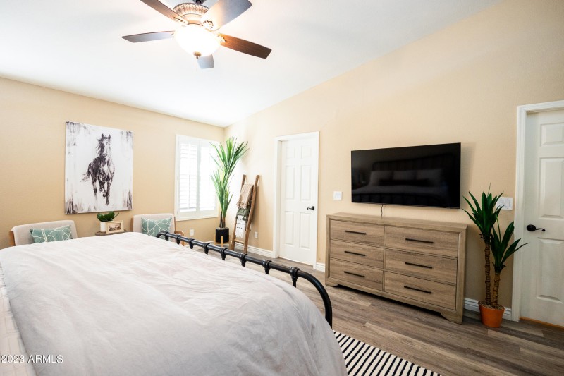 large primary bedroom with smart tv