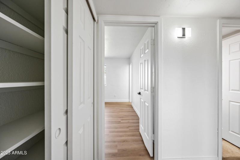 Linen Closet and Door to Primary Suite
