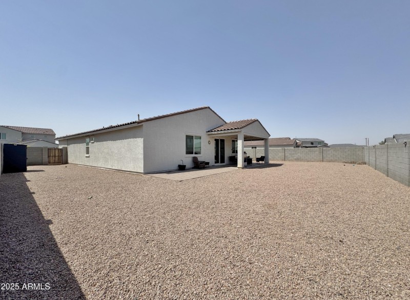 Rear view of home and yard