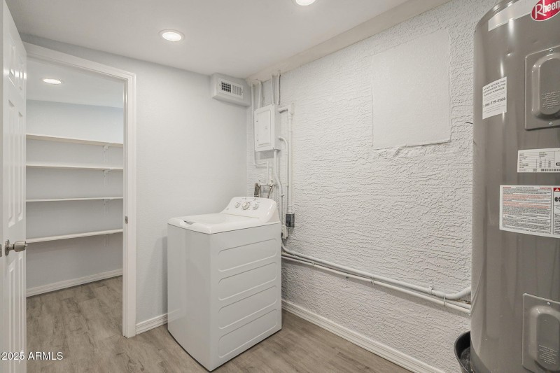 Laundry room with door leading to pantry