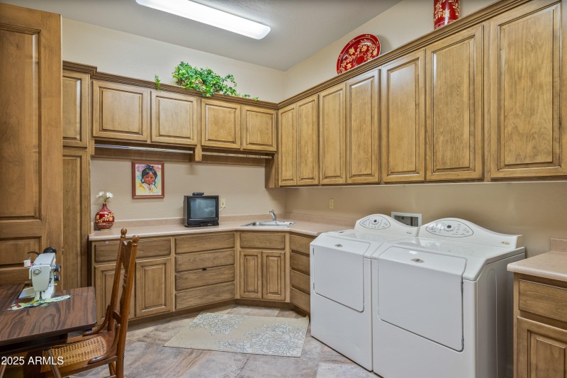 Laundry room with closet