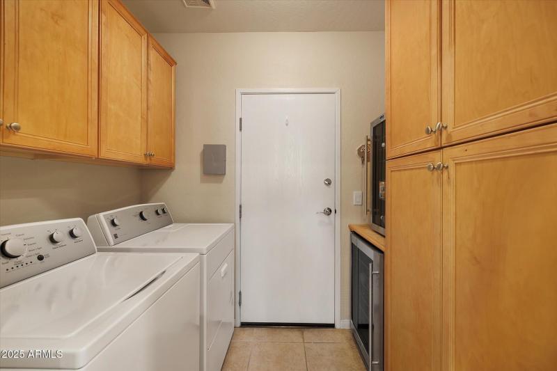 laundry with abundance of cabinets