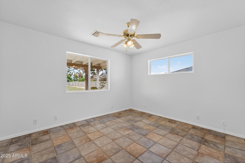 Bedroom 3 with view of backyard
