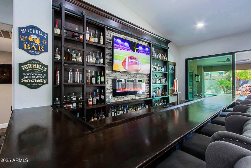 Bar has Library Ladder & Fireplace