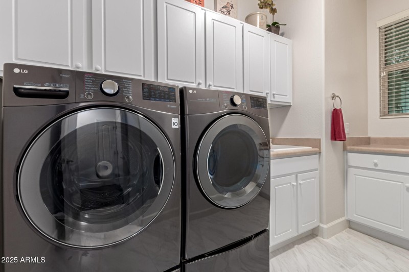 Laundry rm with sink and cabinets