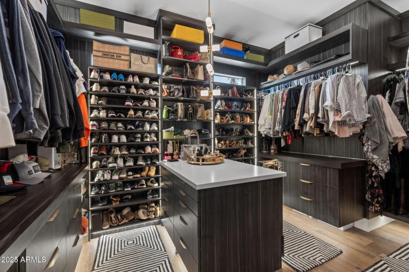 Primary Closet (her) with washer & dryer