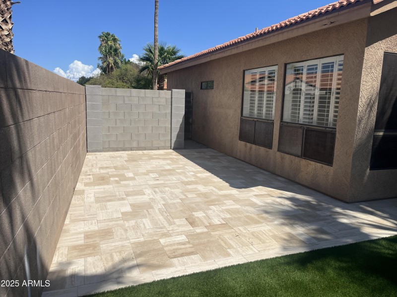 side yard with pavered patio