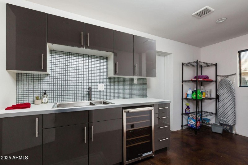 Laundry room with sink and wine fridge