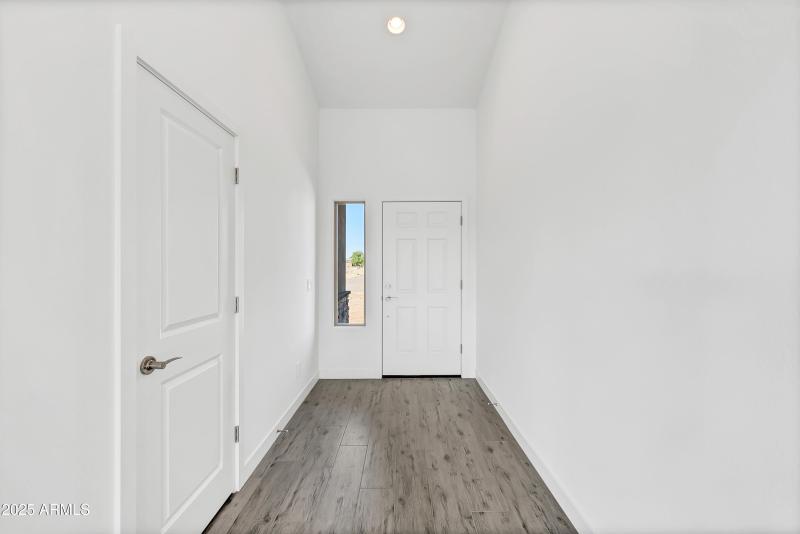 Foyer entry to home with tile.
