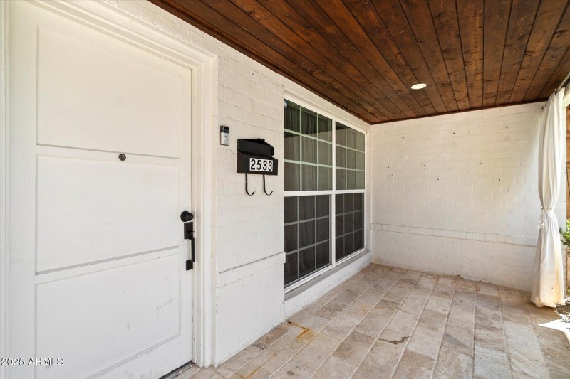 Welcoming Front Porch Wooden Ceilings