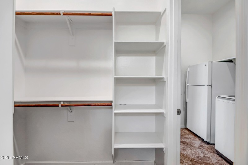 PRIMARY WALKIN CLOSET WITH ACCESS TO UTI