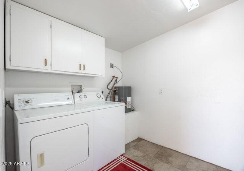 laundry room with addtl water heater