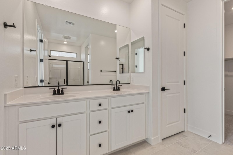 Primary Bathroom with Dual Sinks and Li