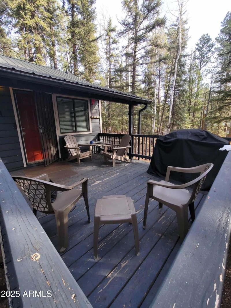 Poarch with grill chairs and table