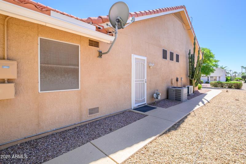 Side View Door to Garage and Lit Pathway