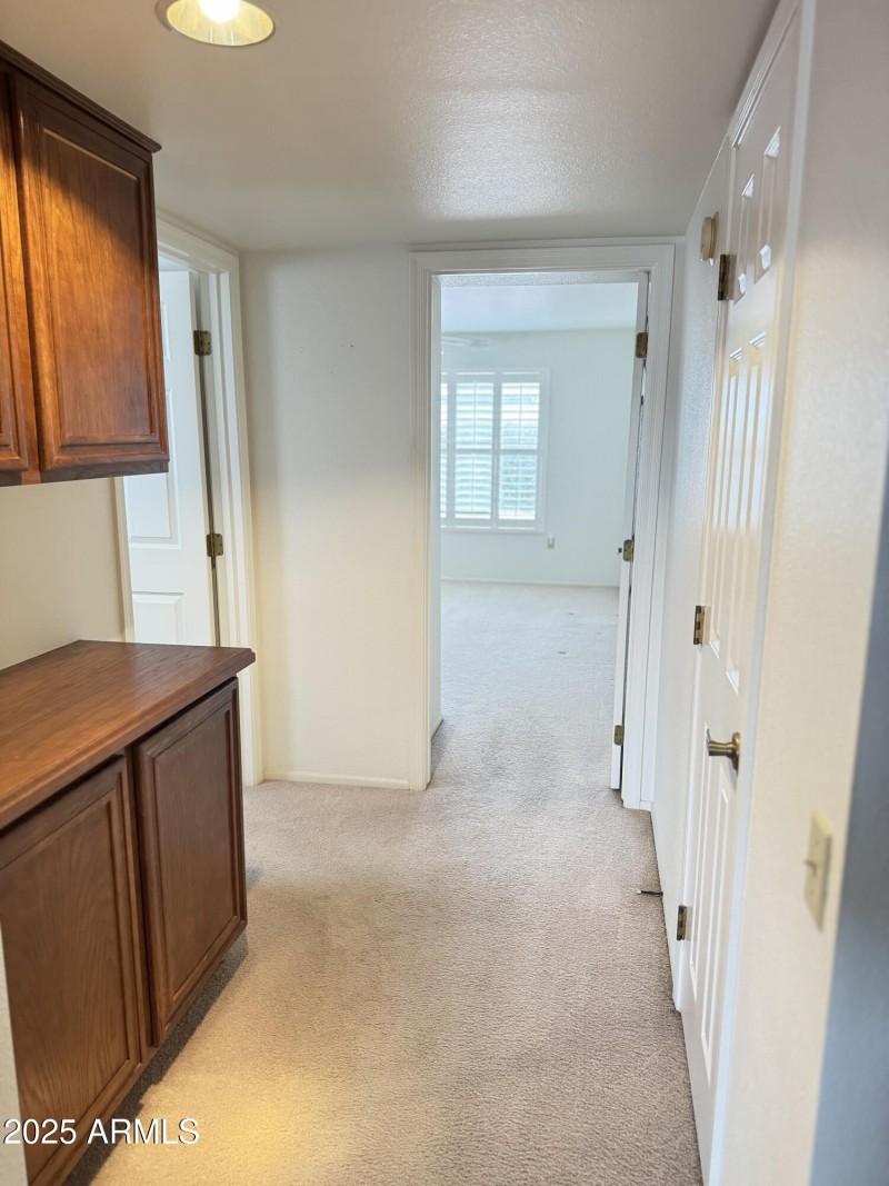 Hall entry to secondary bedroom and bath
