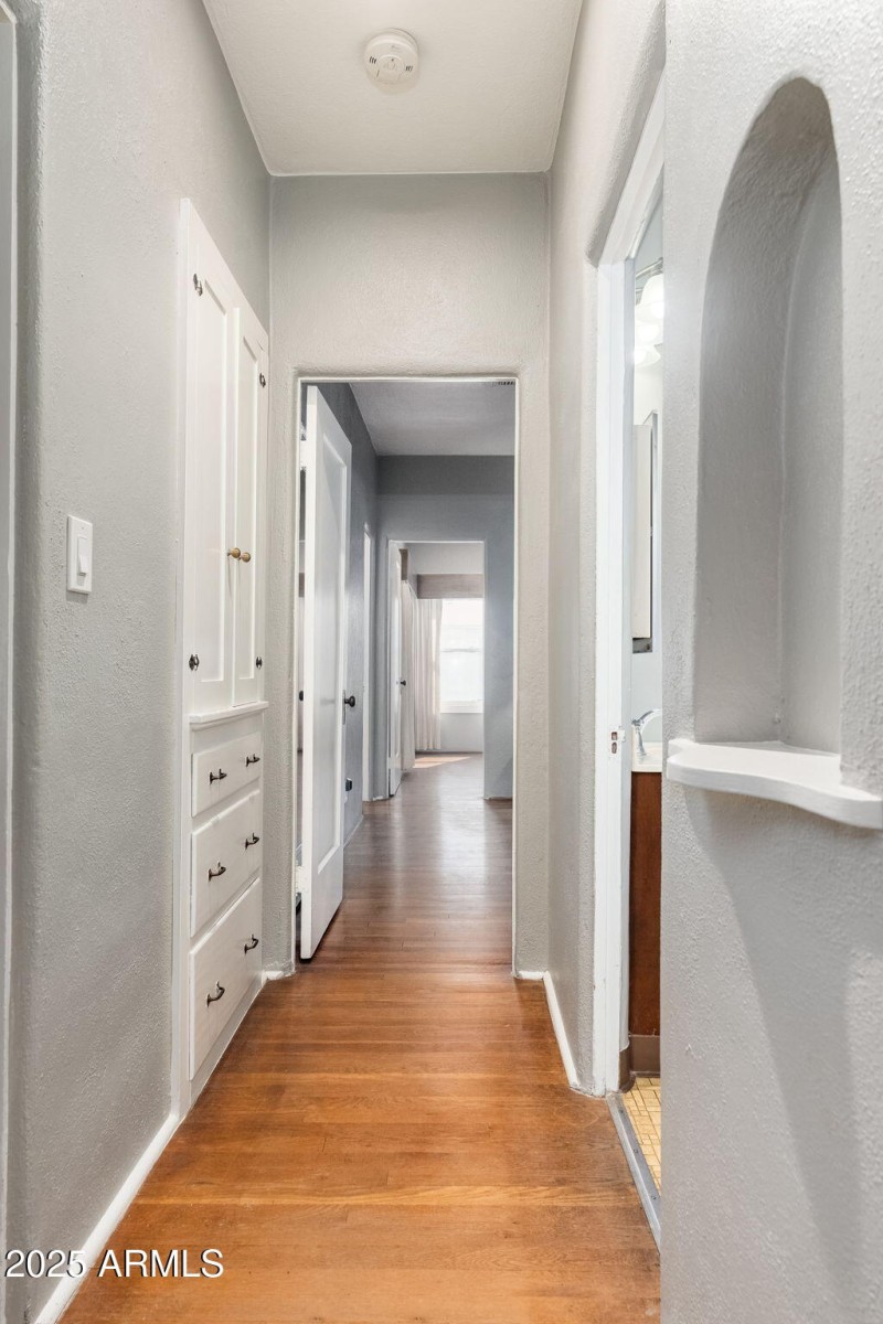 Hallway with built in linen cabinet