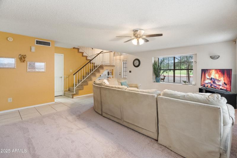 Living Room facing stairs and Park