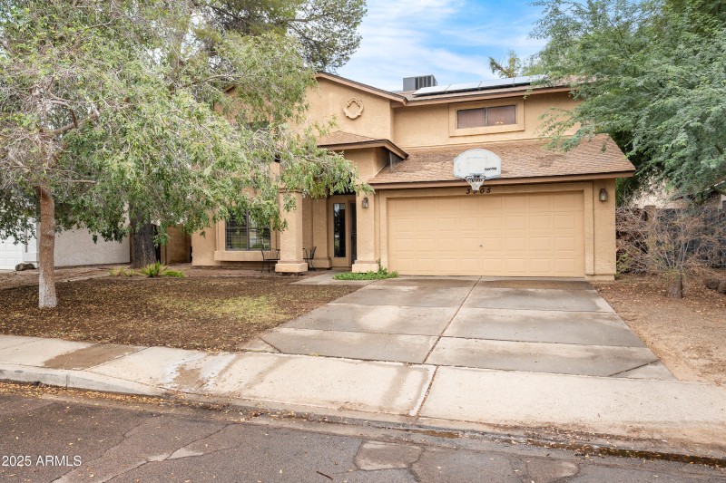 Front of Home showing large shade tree