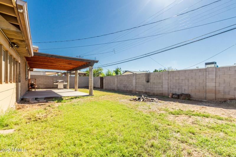 Grass backyard with firepit