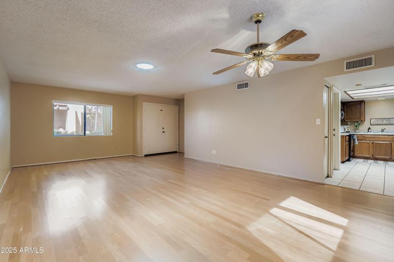 Living room with view into kitchen