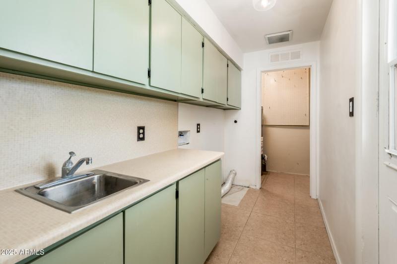 Laundry Room- love the green cabinets
