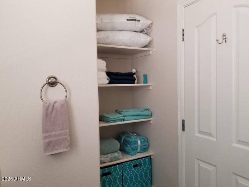 Linen area behind bathroom door