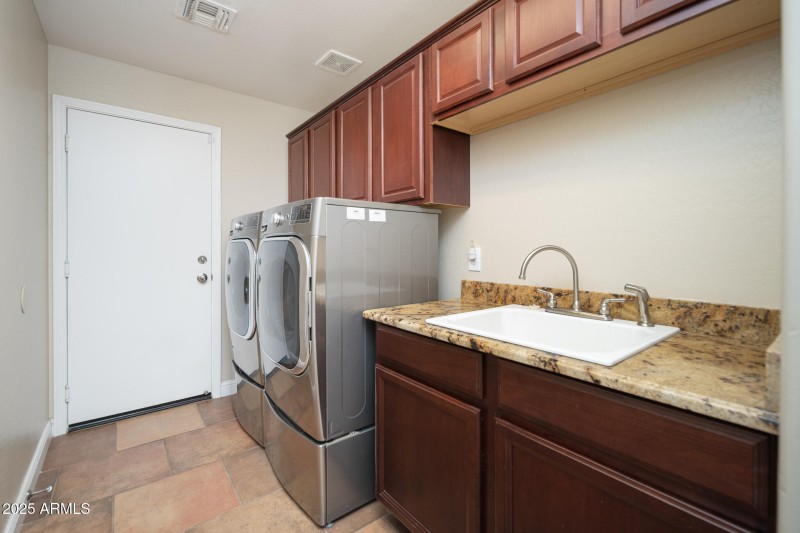 Cabinets and sink at laundry room